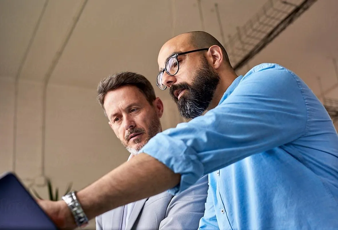Two colleagues reviewing a tablet together